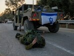 An Israeli soldier mistakenly thinks he hears an air raid siren and jumps to the ground to take cover in Kibbutz Be'eri, An Israeli soldier mistakenly thinks he hears an air raid siren and jumps to the ground to take cover in Kibbutz Be'eri,