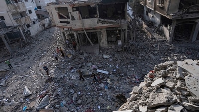Israel Palestine Latest: Palestinians walk through the destruction by Israeli bombing in Gaza City. (AP) Israel Palestine Latest: Palestinians walk through the destruction by Israeli bombing in Gaza City. (AP)