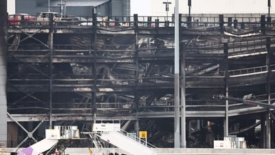 A charred section of a parking structure is seen after it caught fire and partially collapsed at London's Luton Airport. (AFP) A charred section of a parking structure is seen after it caught fire and partially collapsed at London's Luton Airport. (AFP)