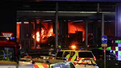 Flames are seen as emergency services respond to a fire in Terminal Car Park 2 at London Luton airport in Luton (REUTERS)