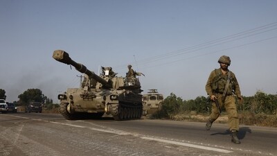Israeli security forces and infantry fighting vehicles move towards the border with Gaza outside Sderot. (Bloomberg) Israeli security forces and infantry fighting vehicles move towards the border with Gaza outside Sderot. (Bloomberg)