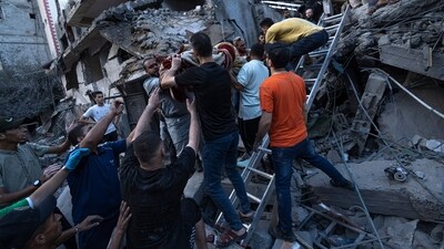 Palestinians rescue a man from the rubble of a destroyed residential building following an Israeli airstrike, Tuesday, Oct. 10, 2023. (AP Photo/Fatima Shbair) (AP)