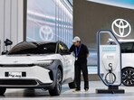 A worker cleans Toyota's Electric Vehicle bZ4X, that is displayed during the Gaikindo Indonesia International Auto Show in Tangerang, near Jakarta, Indonesia.
