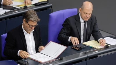 German Minister of Economics and Climate Protection Robert Habeck (L) and German Chancellor Olaf Scholz go through documents during a debate over the Israel-Hamas conflict during a session at the Bundestag, the German lower house of Parliament, in Berlin. Chancellor Olaf Scholz said that “Berlin will ban Hamas activities and organizations linked to the terror group in Germany," reported AFP. (Odd Andersen / AFP) German Minister of Economics and Climate Protection Robert Habeck (L) and German Chancellor Olaf Scholz go through documents during a debate over the Israel-Hamas conflict during a session at the Bundestag, the German lower house of Parliament, in Berlin. Chancellor Olaf Scholz said that “Berlin will ban Hamas activities and organizations linked to the terror group in Germany," reported AFP. (Odd Andersen / AFP)