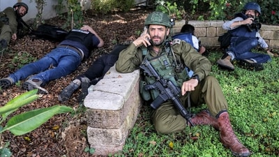 Israeli soldiers and journalists take cover during an alert for a rocket attack in Israel's southern city of Sderot near the border with Gaza on October 12. The Israel government has vowed to annihilate the Hamas outfit that rules the Gaza Strip in retribution for the deadliest attack on Jews since the Holocaust, reported Reuters. (Menahem Kahana / AFP) Israeli soldiers and journalists take cover during an alert for a rocket attack in Israel's southern city of Sderot near the border with Gaza on October 12. The Israel government has vowed to annihilate the Hamas outfit that rules the Gaza Strip in retribution for the deadliest attack on Jews since the Holocaust, reported Reuters. (Menahem Kahana / AFP)
