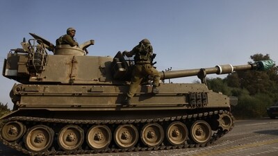 An Israeli army self-propelled gun moves towards the border with Gaza. (Bloomberg) An Israeli army self-propelled gun moves towards the border with Gaza. (Bloomberg)