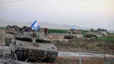 A convoy of Israeli tanks advances near the border with Gaza (AFP) A convoy of Israeli tanks advances near the border with Gaza (AFP)