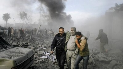 An injured person being helped following a missile strike in the southern Gaza Strip, (AP File) An injured person being helped following a missile strike in the southern Gaza Strip, (AP File)