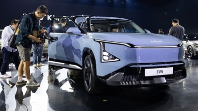 Attendees look at a Kia Corp. EV5 electric vehicle (EV) at the company's EV Day in Yeoju, South Korea, on Thursday, Oct. 12. 2023. Kia unveiled a compact electric sport-utility vehicle and two concept EVs as it builds out a range of cheaper models to appeal to budget-conscious drivers.�Photographer: SeongJoon Cho/Bloomberg (Bloomberg)