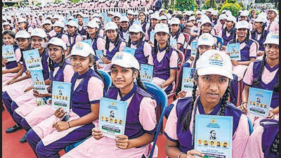 Students with copies of the preamble to the Constitution on the International Day of Democracy, in the city. The 15-member committee will frame a policy to encourage students to inculcate democratic values. (PTI)