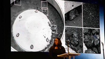 A picture of some of the sample matter collected from the asteroid is displayed during a press conference for the OSIRIS-REx sample unveiling at the Johnson Space Center in Houston, Texas on October 11. (AFP) A picture of some of the sample matter collected from the asteroid is displayed during a press conference for the OSIRIS-REx sample unveiling at the Johnson Space Center in Houston, Texas on October 11. (AFP)