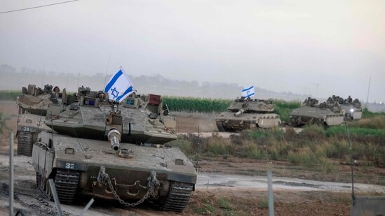 A convoy of Israeli tanks advances near the border with Gaza (AFP)