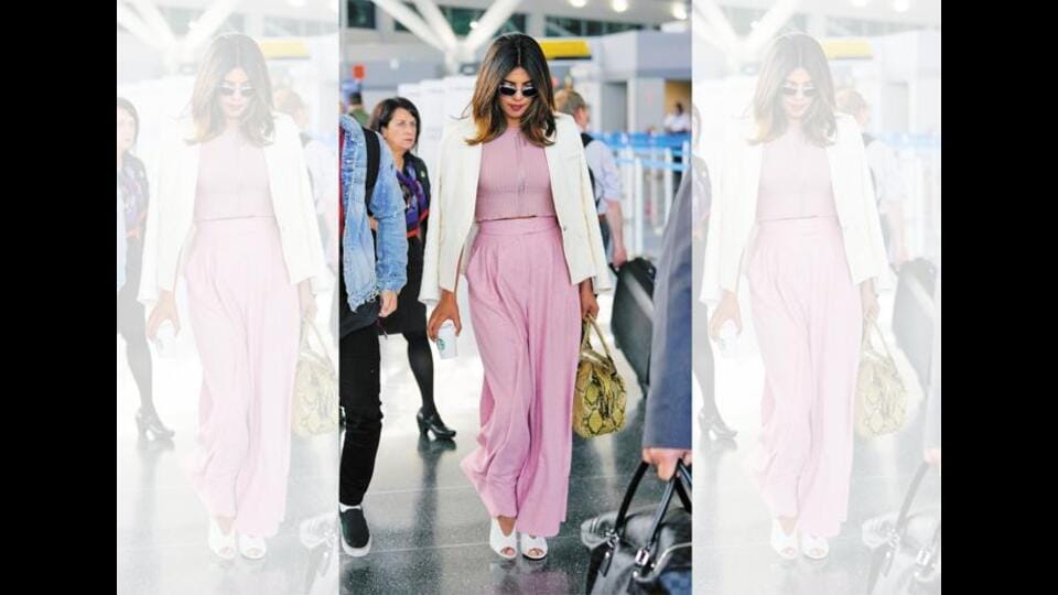 Priyanka Chopra Jonas keeps her airport look simple, adopting trends, but in light, uncrushable fabric. (Getty Images)