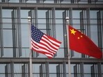 Chinese and US flags flutter outside the building of an American company in Beijing. Chinese and US flags flutter outside the building of an American company in Beijing.