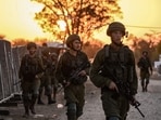 Israeli soldiers patrol at the place where 270 revellers were gunned down or burnt in their cars by Hamas gunmen near kibbutz Beeri during at the Supernova music festival in the Negev desert. Israeli soldiers patrol at the place where 270 revellers were gunned down or burnt in their cars by Hamas gunmen near kibbutz Beeri during at the Supernova music festival in the Negev desert.