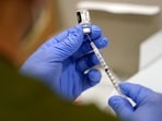 FILE - A healthcare worker fills a syringe with the Pfizer COVID-19 vaccine at Jackson Memorial Hospital on Oct. 5, 2021, in Miami. VAIDS is not a real condition, experts say. The co-authors of the study say their work is being misrepresented and doesn’t show that the vaccine is harmful to the immune system. The false claim is spreading as U.S. health officials recommend most Americans receive an updated COVID-19 vaccine. (AP Photo/Lynne Sladky, File)