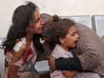 Graphic content: A Palestinian woman comforts her children as they wait at the hospital to be checked, as battles between Israel Hamas continue for the sixth consecutive day, in the city of Rafah, in the southern Gaza Strip on Thursday, Graphic content: A Palestinian woman comforts her children as they wait at the hospital to be checked, as battles between Israel Hamas continue for the sixth consecutive day, in the city of Rafah, in the southern Gaza Strip on Thursday,