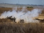 An Israeli army self-propelled howitzer fires rounds towards the Gaza Strip in southern Israel on October 13, 2023. Palestinians carried belongings through the rubble-strewn streets of Gaza City October 13 in search of refuge as Israel's army warned residents to flee immediately before an expected ground offensive in retaliation against Hamas for the deadliest attack in Israeli history. (Photo by JACK GUEZ / AFP)