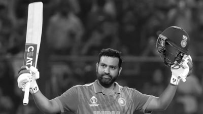 Rohit Sharma raises his bat after scoring a century (Rohit Chawla)