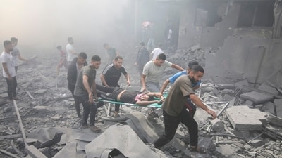 Palestinians evacuate wounded after an Israeli airstrike in Rafah refugee camp in southern Gaza Strip on October 12. (AP) Palestinians evacuate wounded after an Israeli airstrike in Rafah refugee camp in southern Gaza Strip on October 12. (AP)