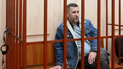 Opposition leader Alexei Navalny's lawyer Igor Sergunin sits in a cage in a courtroom in Moscow, Russia. (AP) Opposition leader Alexei Navalny's lawyer Igor Sergunin sits in a cage in a courtroom in Moscow, Russia. (AP)