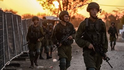 Israeli soldiers patrol at the place where 270 revellers were gunned down or burnt in their cars by Hamas gunmen near kibbutz Beeri during at the Supernova music festival in the Negev desert. (AFP) Israeli soldiers patrol at the place where 270 revellers were gunned down or burnt in their cars by Hamas gunmen near kibbutz Beeri during at the Supernova music festival in the Negev desert. (AFP)