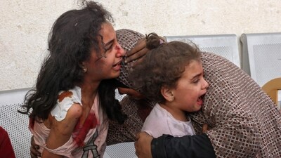 Graphic content: A Palestinian woman comforts her children as they wait at the hospital to be checked, as battles between Israel Hamas continue for the sixth consecutive day, in the city of Rafah, in the southern Gaza Strip on Thursday, (AFP) Graphic content: A Palestinian woman comforts her children as they wait at the hospital to be checked, as battles between Israel Hamas continue for the sixth consecutive day, in the city of Rafah, in the southern Gaza Strip on Thursday, (AFP)