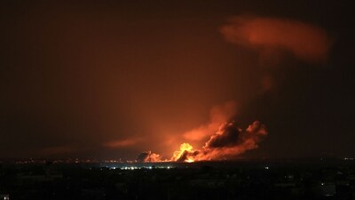 A ball of fire errupts and smoke billows on the horizon during an Israeli air strike in Khan Yunis on the southern Gaza Strip. (AFP) A ball of fire errupts and smoke billows on the horizon during an Israeli air strike in Khan Yunis on the southern Gaza Strip. (AFP)