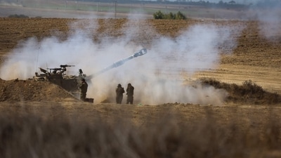 An Israeli army self-propelled howitzer fires rounds towards the Gaza Strip in southern Israel on October 13, 2023. Palestinians carried belongings through the rubble-strewn streets of Gaza City October 13 in search of refuge as Israel's army warned residents to flee immediately before an expected ground offensive in retaliation against Hamas for the deadliest attack in Israeli history. (Photo by JACK GUEZ / AFP) (AFP) An Israeli army self-propelled howitzer fires rounds towards the Gaza Strip in southern Israel on October 13, 2023. Palestinians carried belongings through the rubble-strewn streets of Gaza City October 13 in search of refuge as Israel's army warned residents to flee immediately before an expected ground offensive in retaliation against Hamas for the deadliest attack in Israeli history. (Photo by JACK GUEZ / AFP) (AFP)