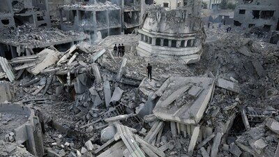 Palestinians inspect the rubble of the Yassin Mosque destroyed after it was hit by an Israeli airstrike at Shati refugee camp in Gaza City. (AP)