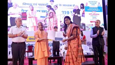 U.P. chief minister Yogi Adityanath handing over appointment letter to a principal at Lok Bhavan in Lucknow on Oct 13. (HT photo)