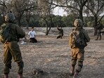 Israeli soldiers detain a man while on patrol near Kibbutz Beeri, the place where 270 revellers were killed by Hamas militants during the Supernova music festival on October 7. Israeli soldiers detain a man while on patrol near Kibbutz Beeri, the place where 270 revellers were killed by Hamas militants during the Supernova music festival on October 7.
