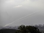 A picture taken from the Israeli city of Sderot shows rockets being fired towards Israel from the northern Gaza Strip on October 14, 2023. 