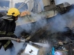 Israel-Hamas War: A Palestinian firefighter extinguishes fire amid the rubble of a house after it was hit by Israeli strikes, in Khan Younis in the southern Gaza Strip.