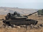 Israeli soldiers stand on a stationed tank near the border with Israel, in Lebanon, Saturday Oct. 14, 2023. Israeli soldiers stand on a stationed tank near the border with Israel, in Lebanon, Saturday Oct. 14, 2023.