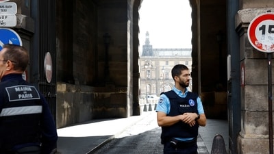 French police officers keep watch outside of the Louvre museum, closed for security reasons, in Paris. (Reuters)
