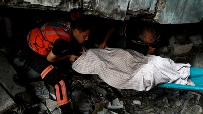 Rescuers recover a body from under the rubble in the aftermath of Israeli strikes, amid the ongoing conflict between Israel and the Palestinian Islamist group Hamas, in Khan Younis in the southern Gaza Strip. (REUTERS)