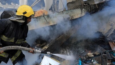 Israel-Hamas War: A Palestinian firefighter extinguishes fire amid the rubble of a house after it was hit by Israeli strikes, in Khan Younis in the southern Gaza Strip. (Reuters)