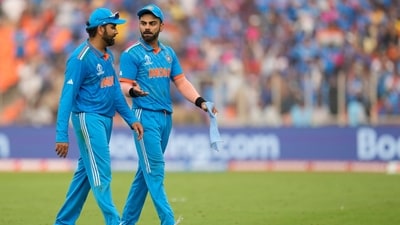 Virat Kohli and Rohit Sharma discuss while leaving the field after India bowled out Pakistan for 191. (AP)