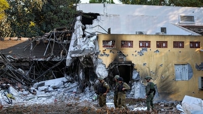 Israeli soldiers walk past houses destroyed by Hamas militants in Kibbutz Be'eri, Israel, (AP) Israeli soldiers walk past houses destroyed by Hamas militants in Kibbutz Be'eri, Israel, (AP)