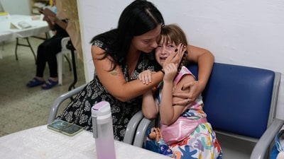 Israelis take cover in a shelter as a siren sounds a warning of incoming rockets fired from the Gaza strip, in Ashkelon, Israel, (AP) Israelis take cover in a shelter as a siren sounds a warning of incoming rockets fired from the Gaza strip, in Ashkelon, Israel, (AP)