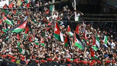 Palestine supporters the Palestinian and Jordanian flags during a demonstration in Amman. Thousands of protesters poured onto the streets of several Middle East capitals in support of Palestinians amid Israeli air strikes on Gaza. (AFP)