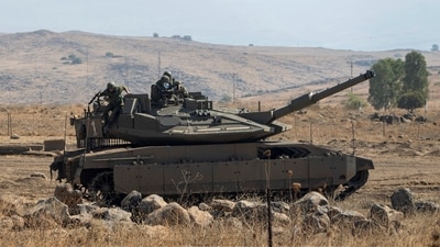 Israeli soldiers stand on a stationed tank near the border with Israel, in Lebanon, Saturday Oct. 14, 2023. (AP) Israeli soldiers stand on a stationed tank near the border with Israel, in Lebanon, Saturday Oct. 14, 2023. (AP)