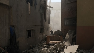 Israel-Hamas War: A Palestinian man inspects the damage to a building after Israeli strikes, in Khan Yunis in the southern Gaza Strip. (AFP) Israel-Hamas War: A Palestinian man inspects the damage to a building after Israeli strikes, in Khan Yunis in the southern Gaza Strip. (AFP)
