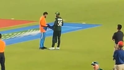 Virat Kohli hands Babar Azam an autographed jersey. Virat Kohli hands Babar Azam an autographed jersey.