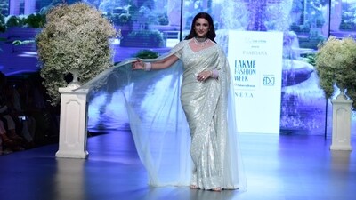 Parineeti Chopra represented the 'Qurbat' collection by Faabiiana that encapsulates the timeless essence of the "Romance of the Rose." The ramp look was quite close to Parineeti's own wedding look in champagne shade lehenga and white veil.&nbsp; 