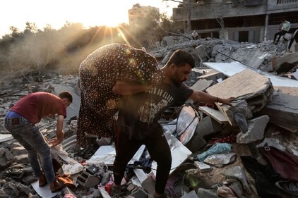 People inspect the damage to their home after Israeli strikes in the Rafah camp on the southern Gaza Strip on October 14. (AFP) People inspect the damage to their home after Israeli strikes in the Rafah camp on the southern Gaza Strip on October 14. (AFP)