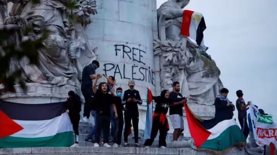 Pro-Palestinian protestors holding Palestine flags during a demonstration in central Paris. The protestors staged the demonstration even after the French government put a ban on it.&nbsp;(Reuters)