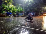 A motorcyclist caught in rain, in Thiruvananthapuram.