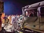 Police personnel at the spot after a speeding mini-bus hit a container on Samruddhi Expressway, in Chhatrapati Sambhajinagar district, early Sunday morning.